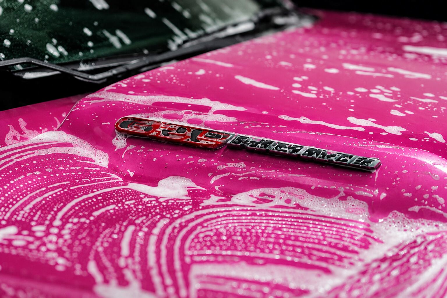 Pink vehicle covered in foam wash